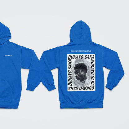 Rich Bright Blue Arsenal Bukayo Saka hoodie by Goalartzo laying flat against a pale background. You can see both sides of the hoodie laid flat. There is a logo on the front chest reading 'goalartzo' and a large black and white graphic design featuring Bukayo Saka Art on the back.